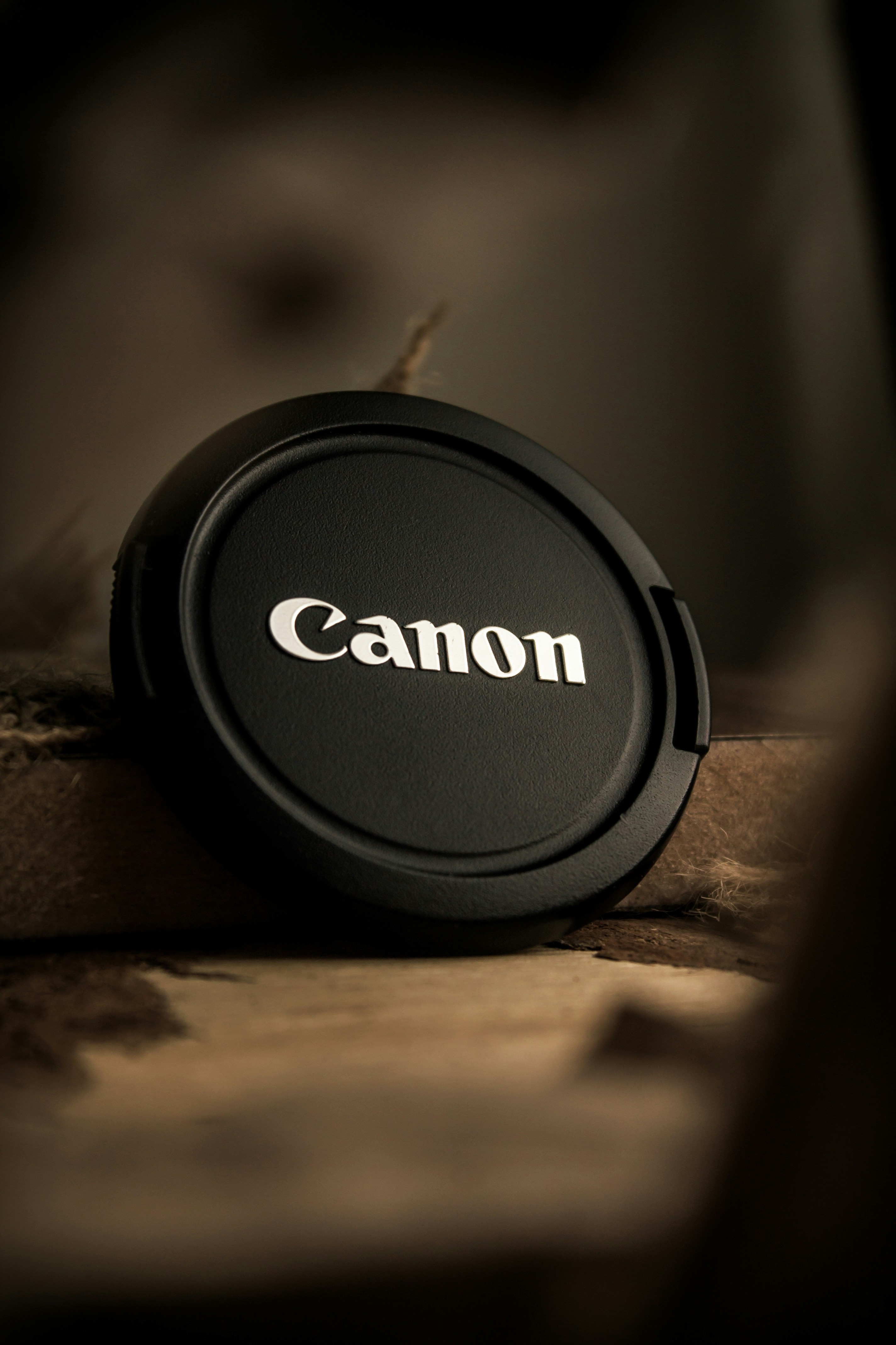 a canon lens cap sitting on top of a table
