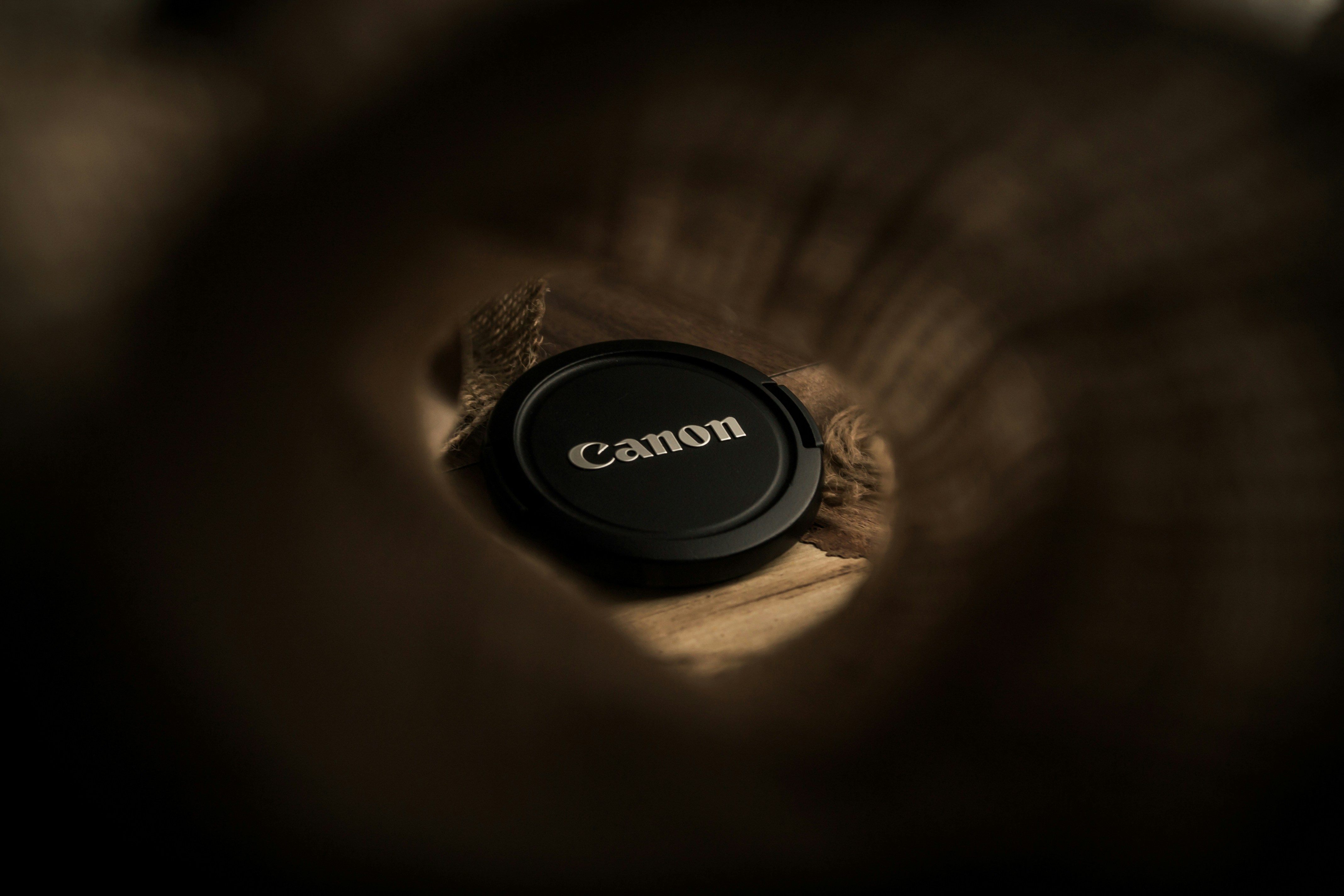 a camera lens cap with the word canon on it
