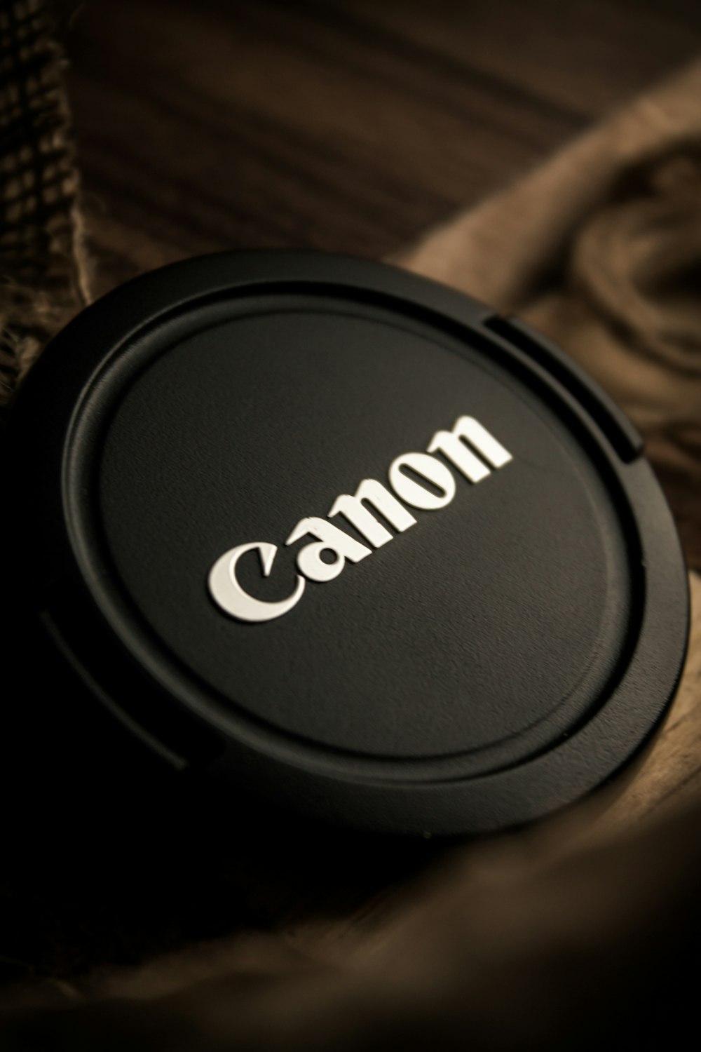 a camera lens cap sitting on top of a wooden table