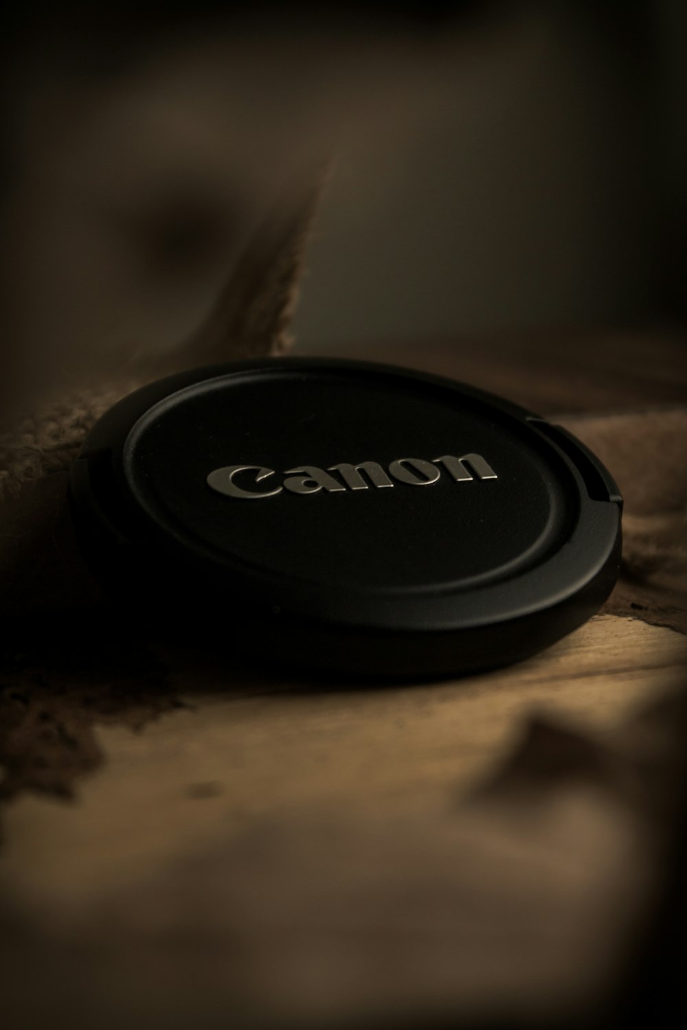 a camera lens cap sitting on top of a bed