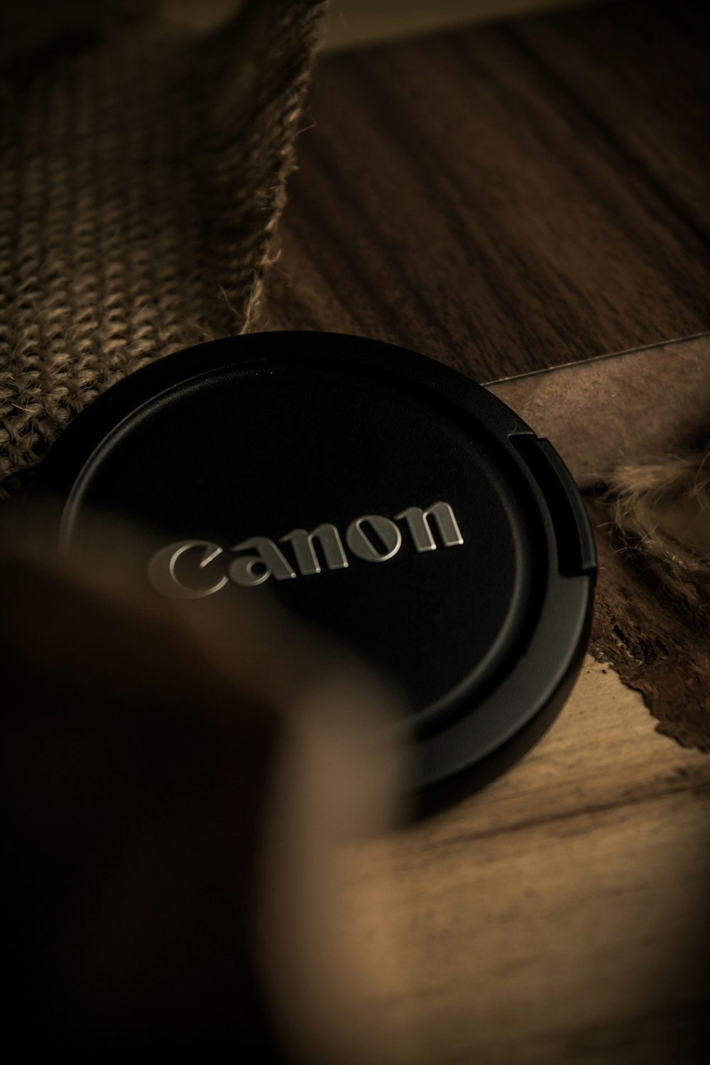 a camera lens cap sitting on top of a wooden table