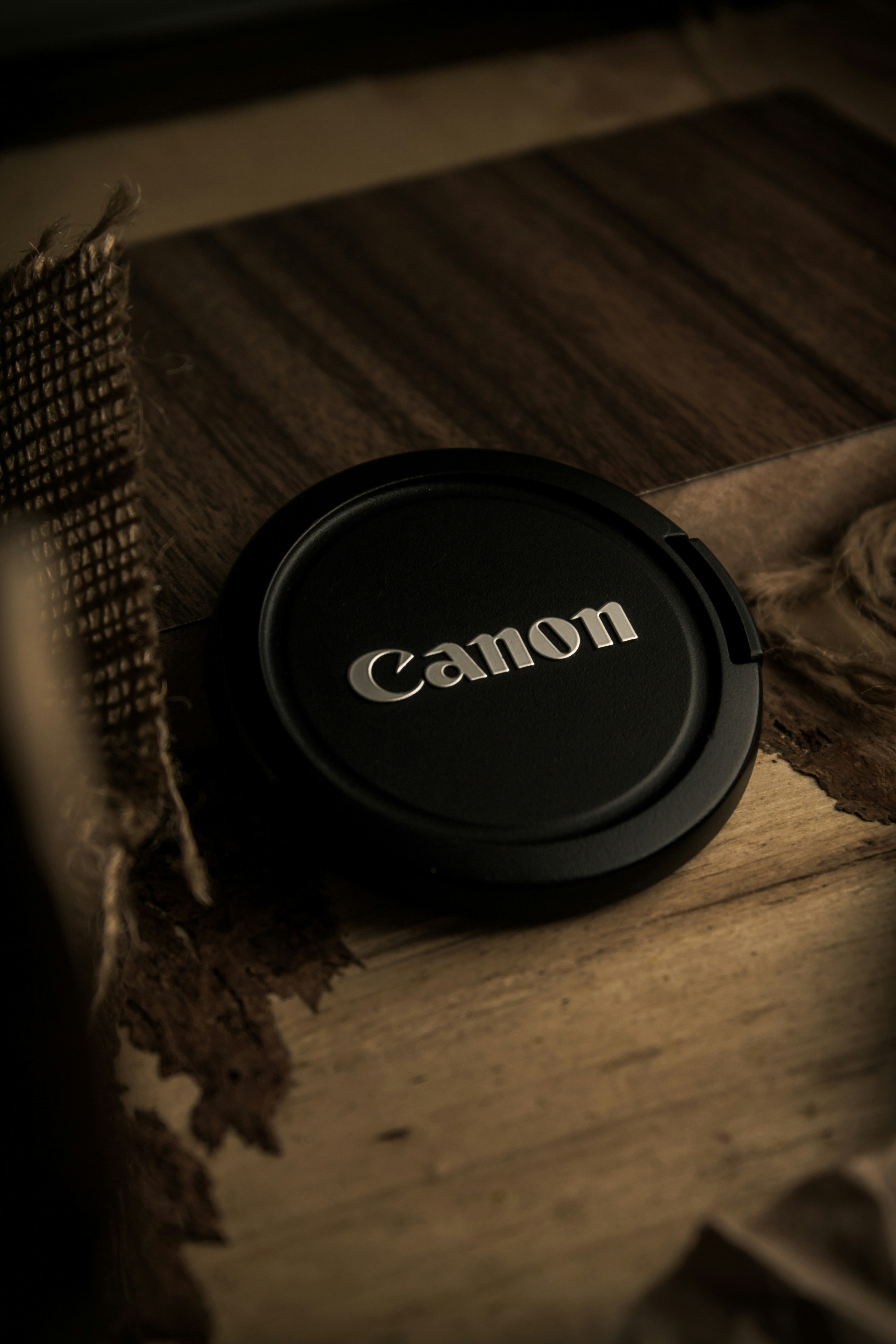 a camera lens cap sitting on top of a wooden table