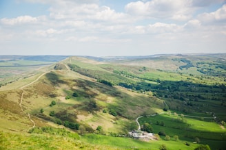 A panoramic view of North Alabama’s rolling hills with a small business office building nestled among trees.