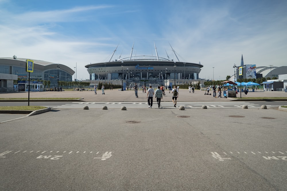 a group of people walking across a parking lot