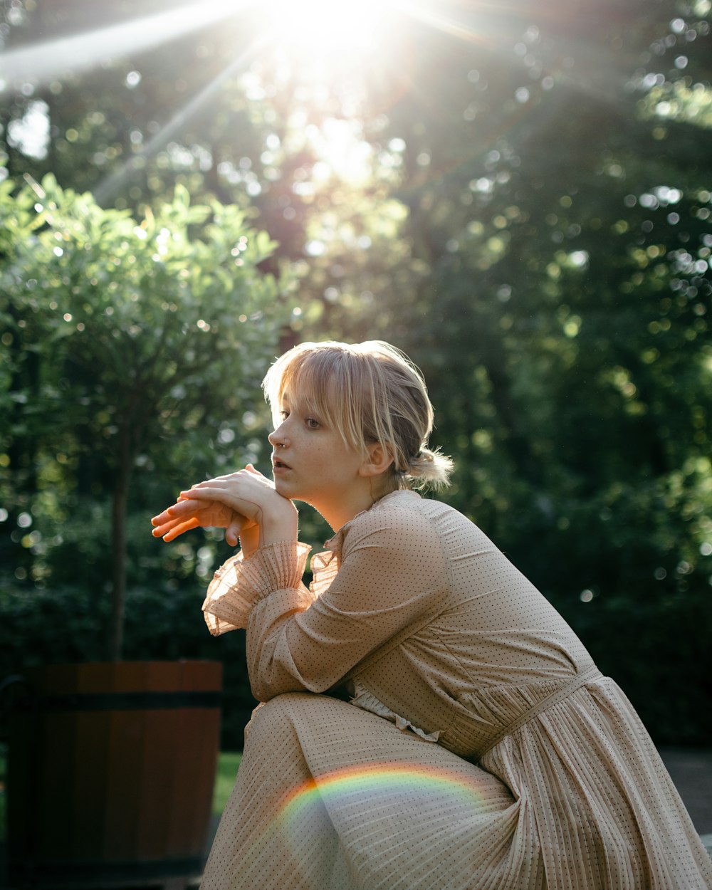 a woman in a dress sitting on a bench