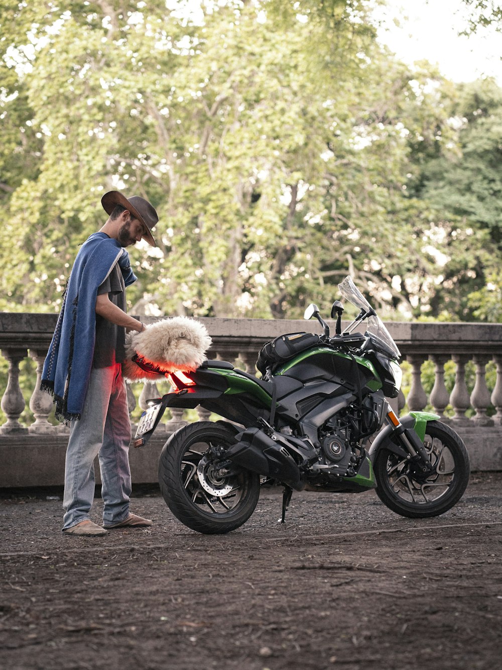 a man standing next to a motorcycle with a dog on it