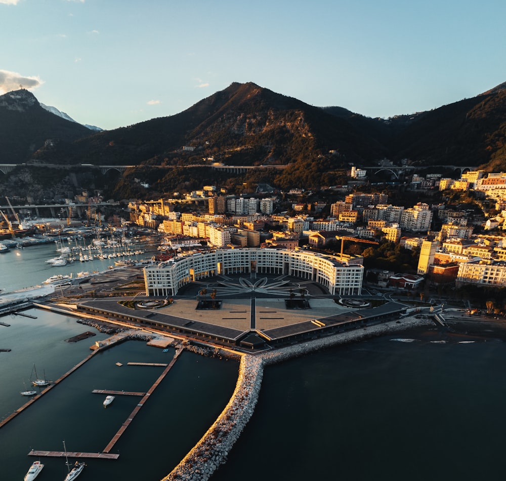 an aerial view of a city with mountains in the background