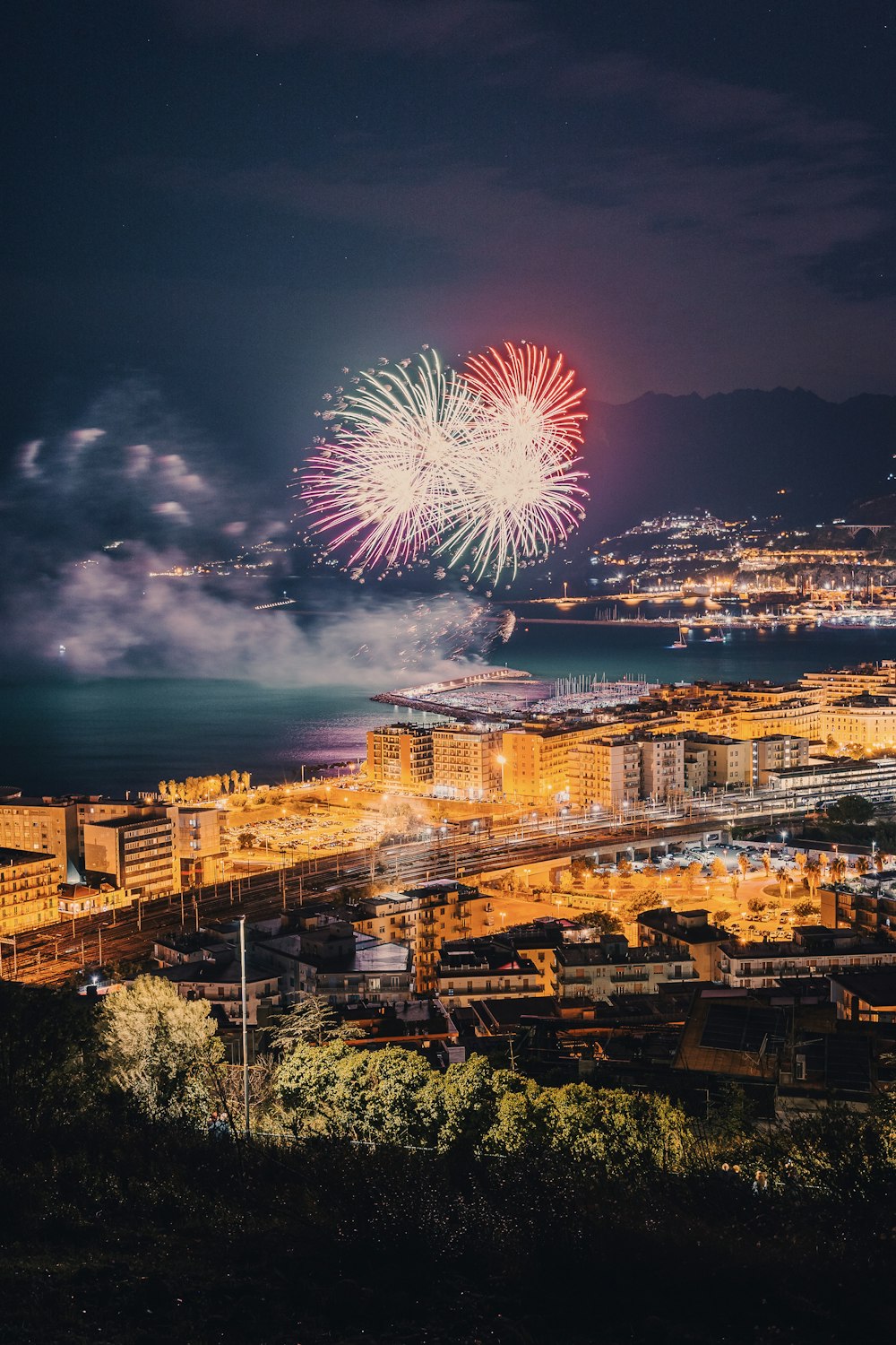 a fireworks display over a city at night