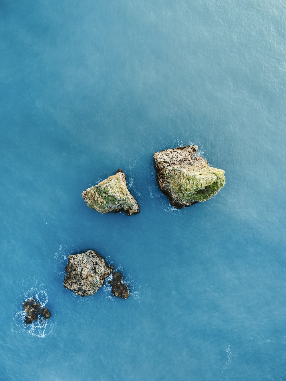 a couple of rocks that are in the water