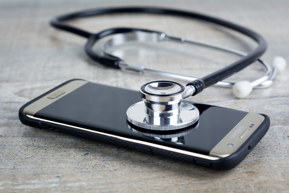 A smart phone with a stethoscope on top of it photo – Free Phone Image on  Unsplash