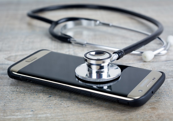 a smart phone with a stethoscope on top of it