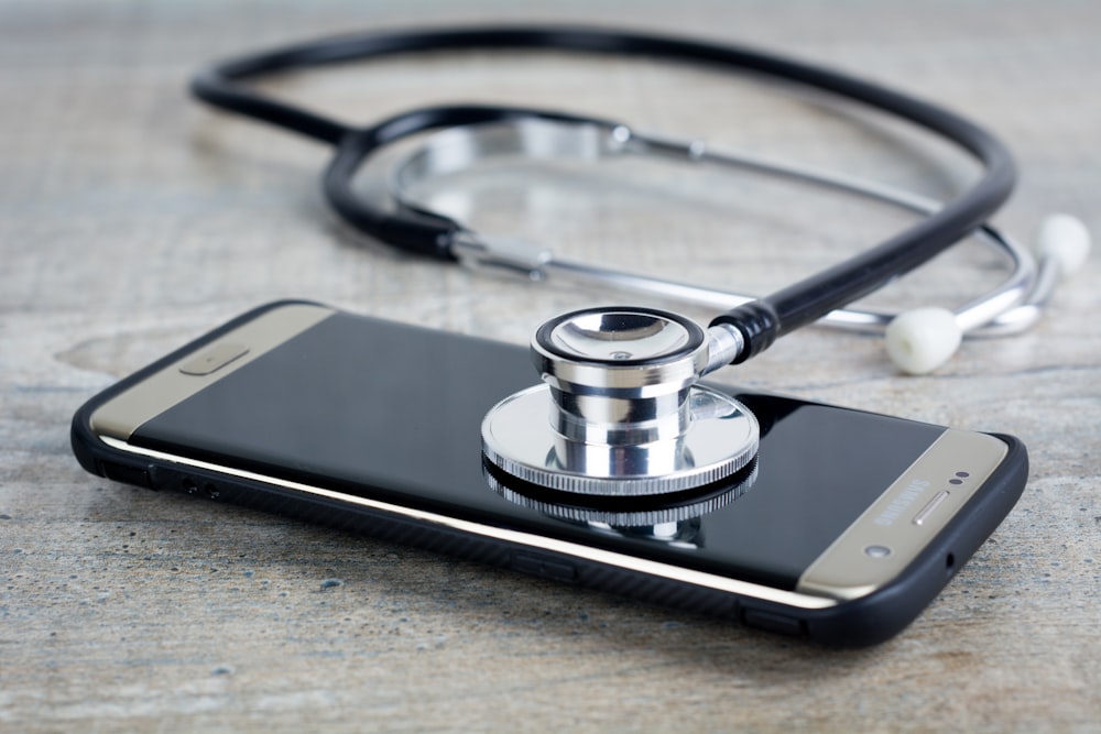 a smart phone with a stethoscope on top of it