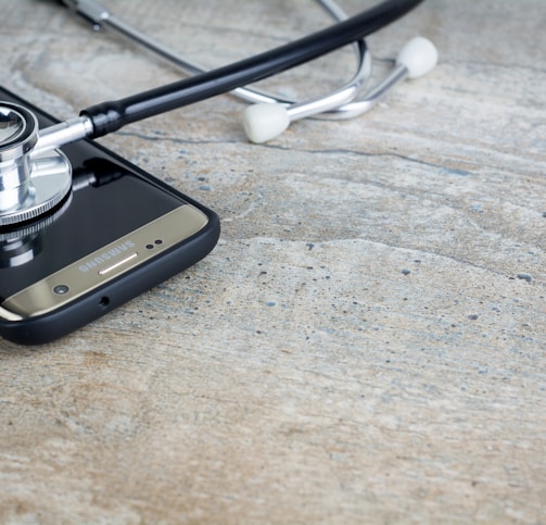 a phone with a stethoscope on top of it