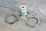 a pair of scissors and a roll of money on a table