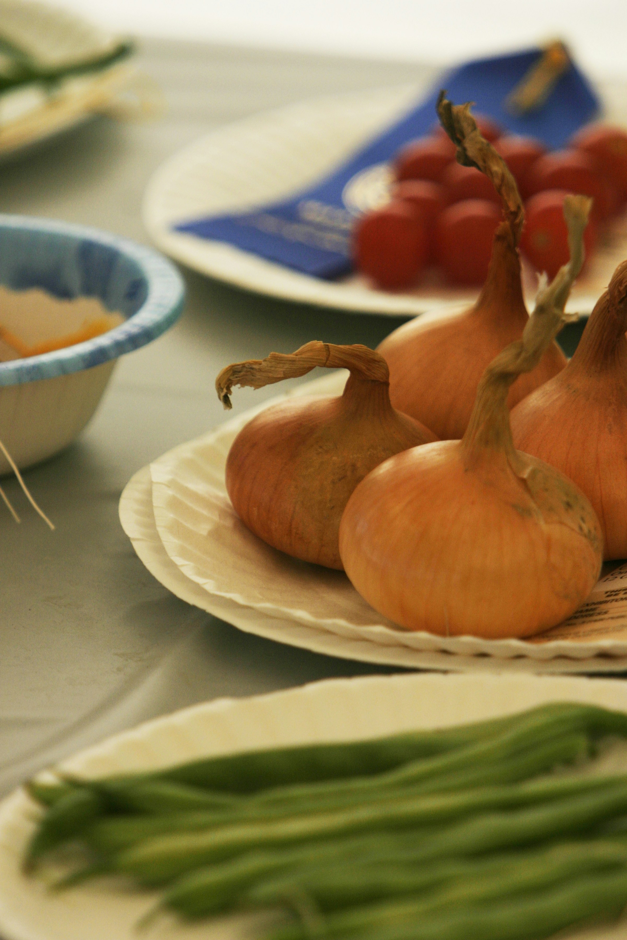 a table topped with plates of food and vegetables