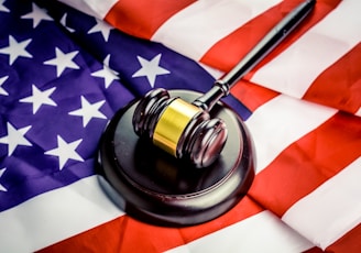 a judge's gavel on top of a flag