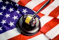 a judge's gavel on top of a flag