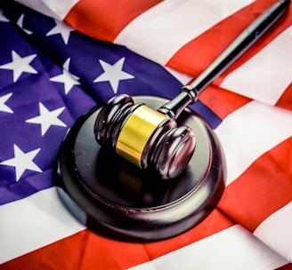 a judge's gavel on top of a flag