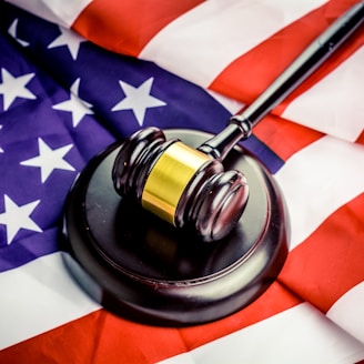 a judge's gavel on top of a flag