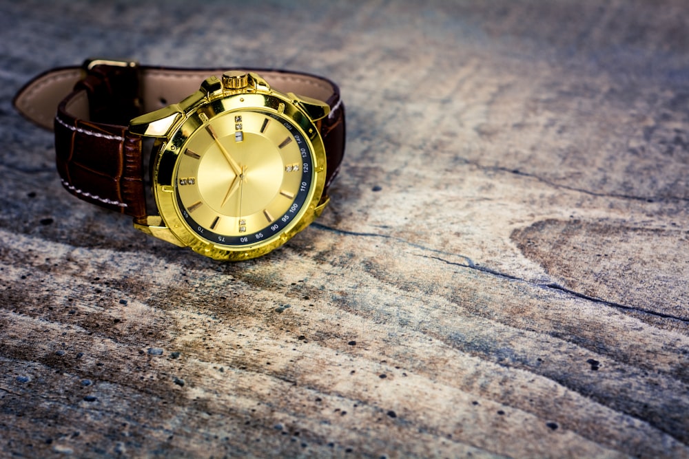 a watch sitting on top of a wooden table