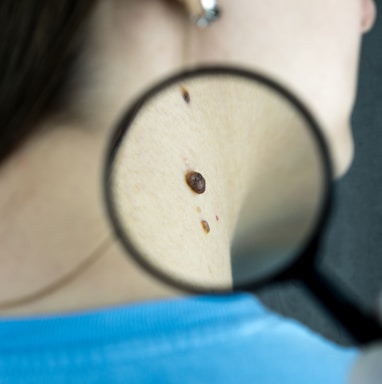 a close up of a person looking through a magnifying glass