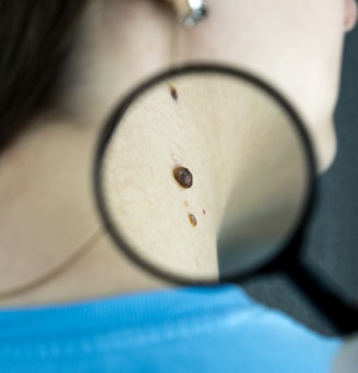 a close up of a person looking through a magnifying glass