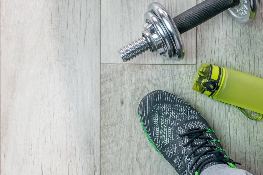 Fitness essentials with dumbbell shoe and water bottle
