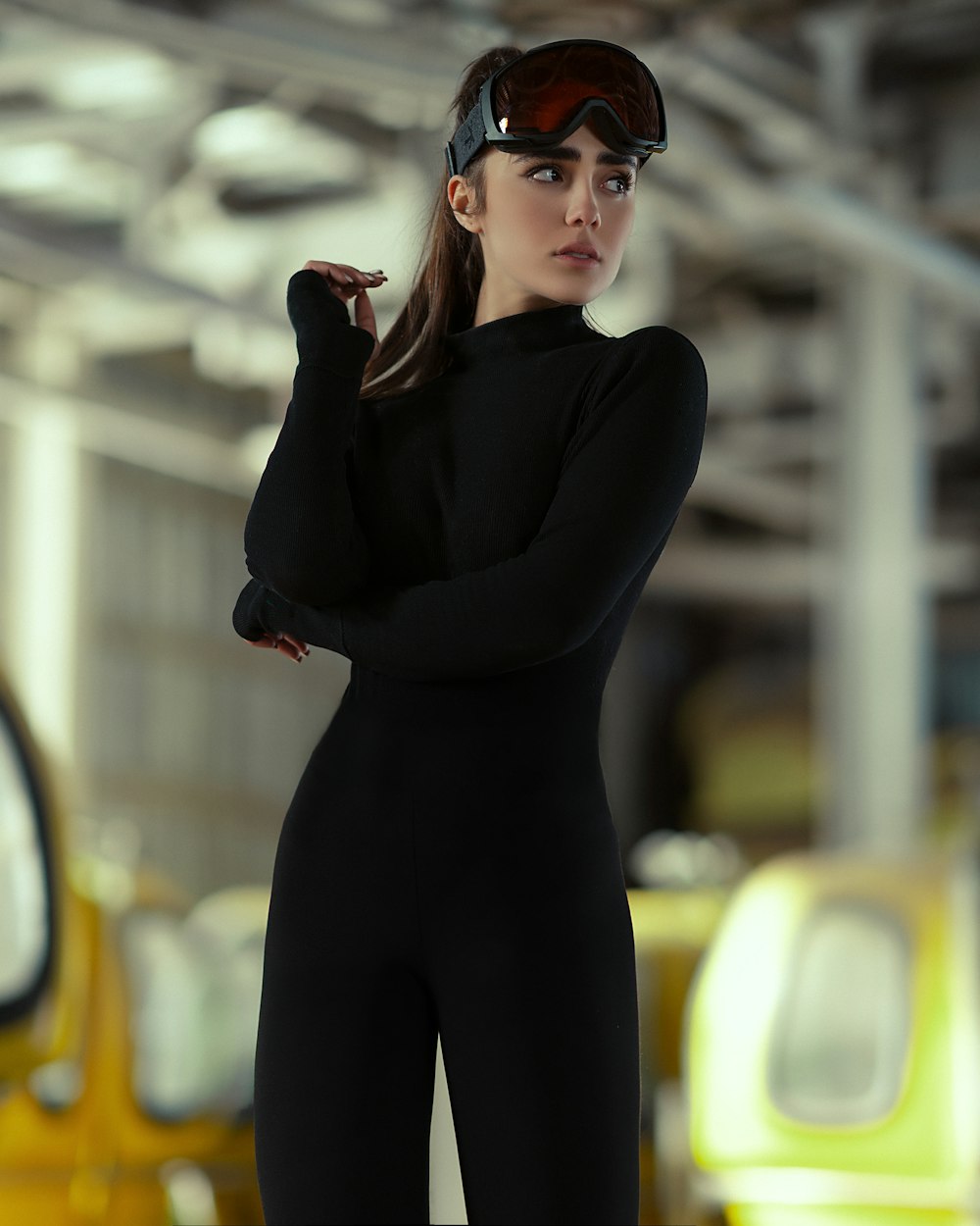 a woman in a black bodysuit and goggles