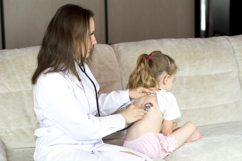 Child using an inhaler during an asthma checkup