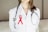a female doctor wearing a red ribbon and a stethoscope