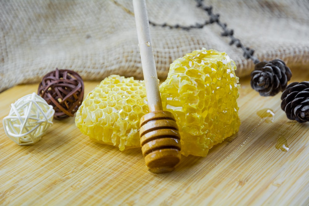 a wooden table topped with honeycombs and pine cones