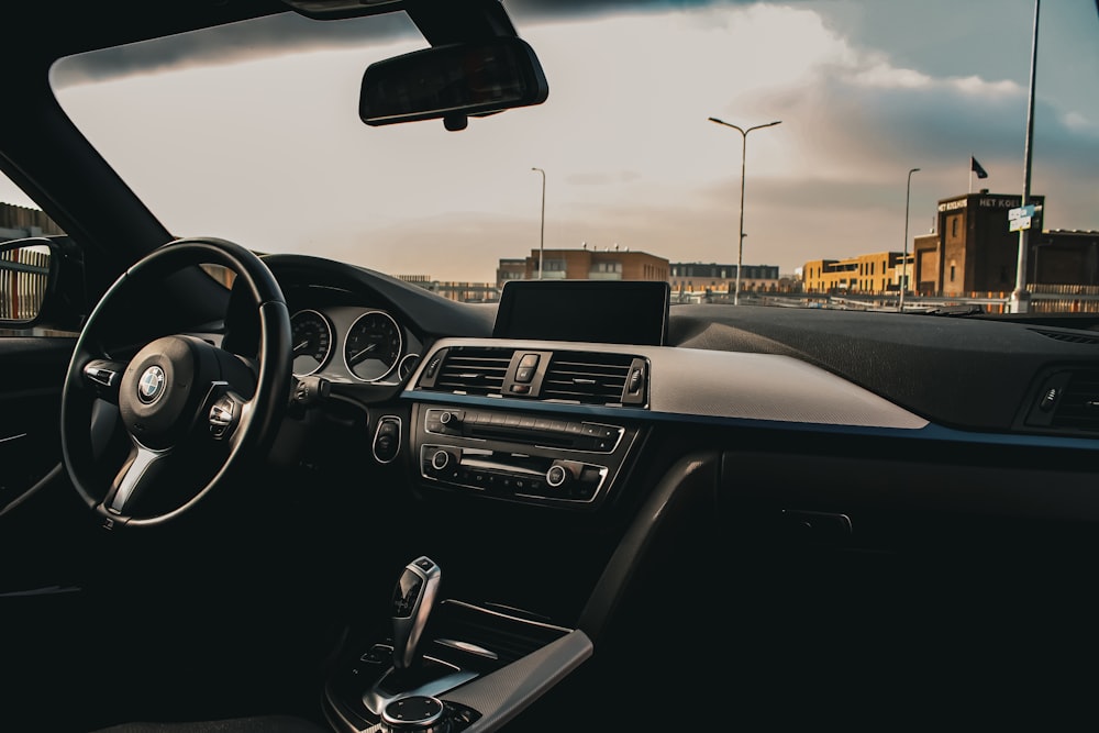 a car dashboard with a steering wheel and dashboard lights