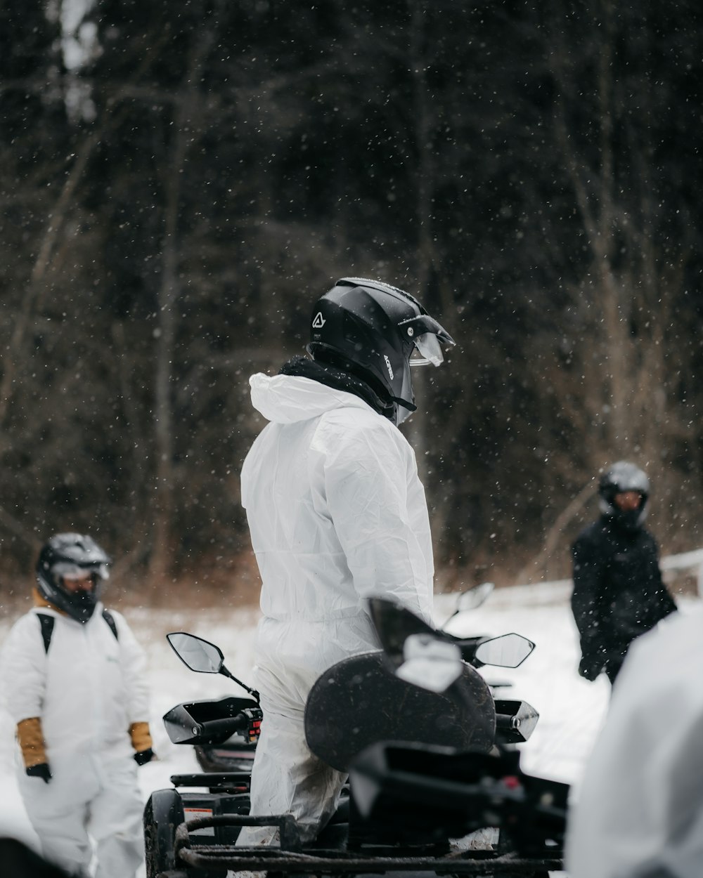 a person in a white suit and helmet on a motorcycle