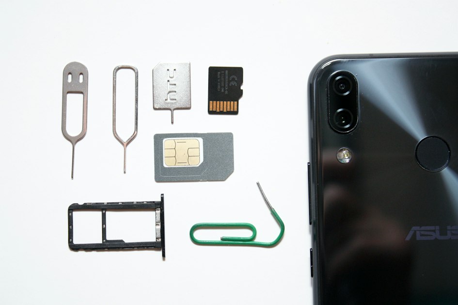 Close-up of a smartphone with a SIM card, illustrating mobile eSIM setup.