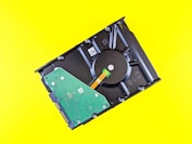 a hard drive being removed from a laptop