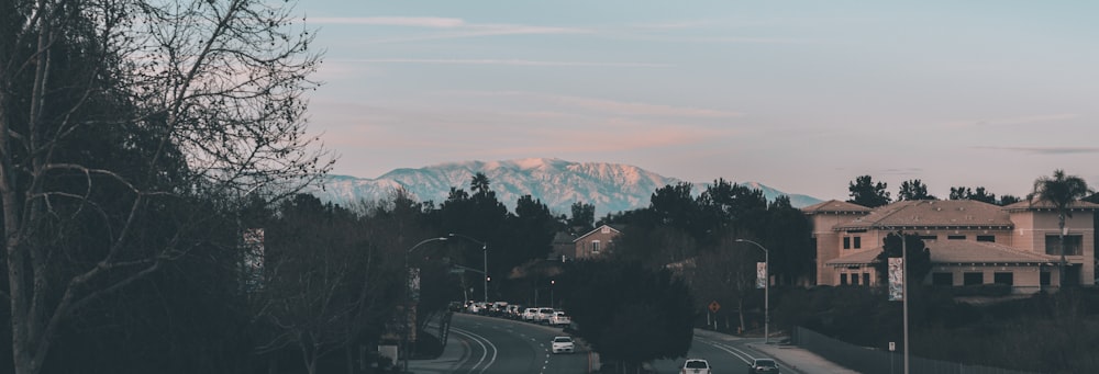 a city street with a mountain in the background