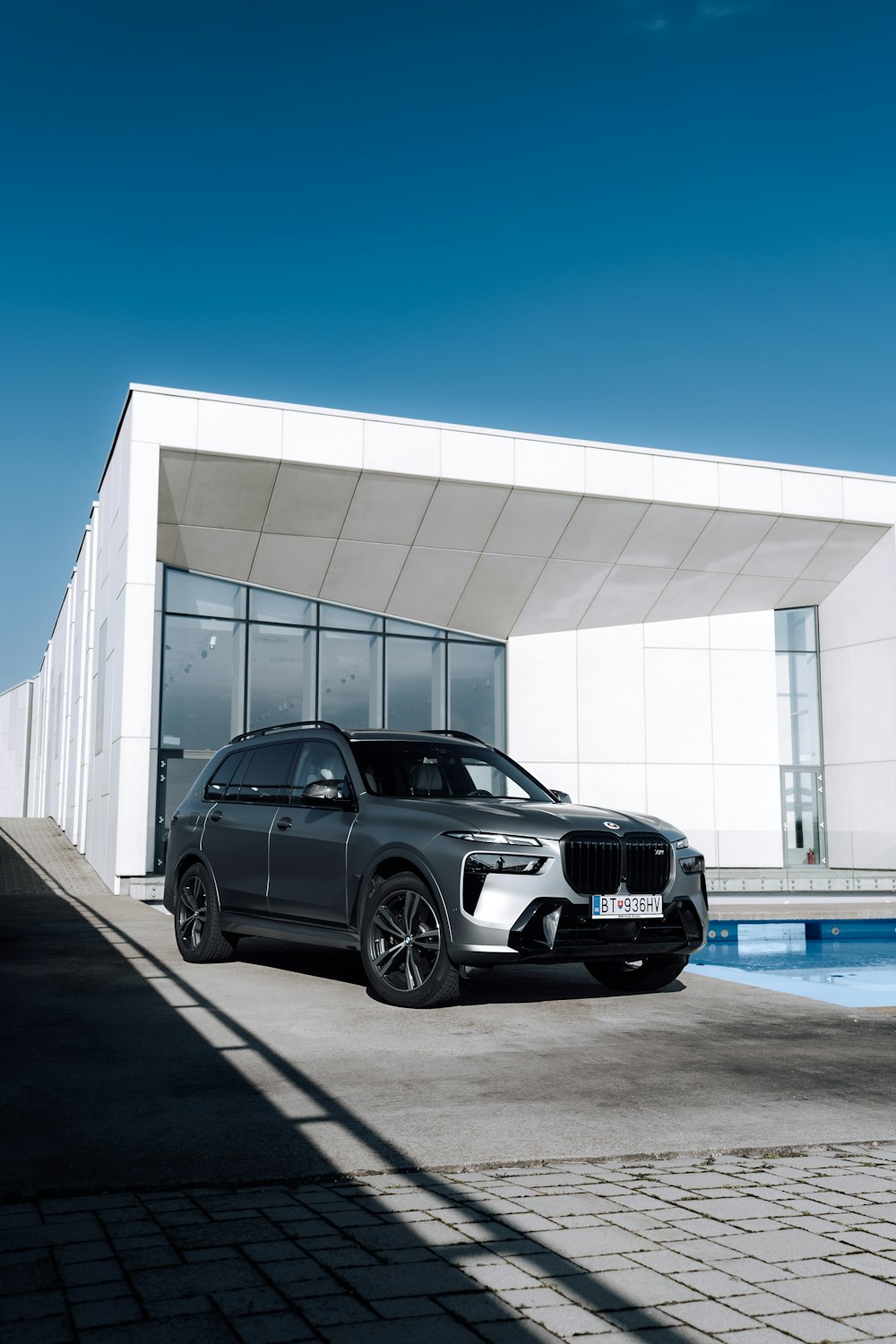 a black car parked in front of a white building