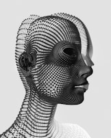 A dynamic wireframe model of a human head with digital paint splashes.