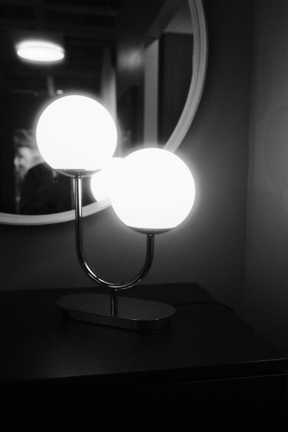 a black and white photo of two lights on a table