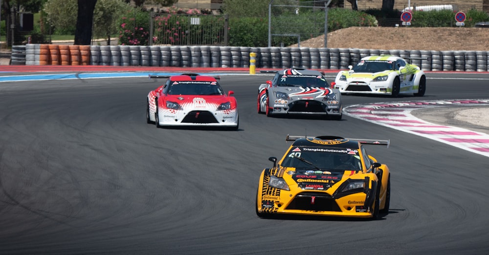 a group of cars driving down a race track