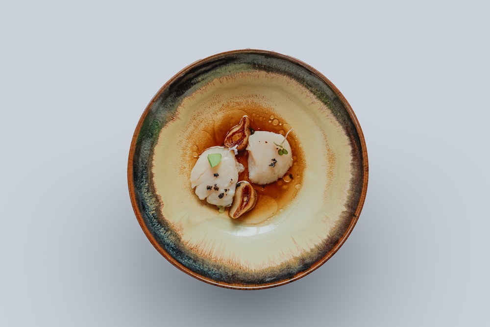 a small bowl filled with food on top of a table