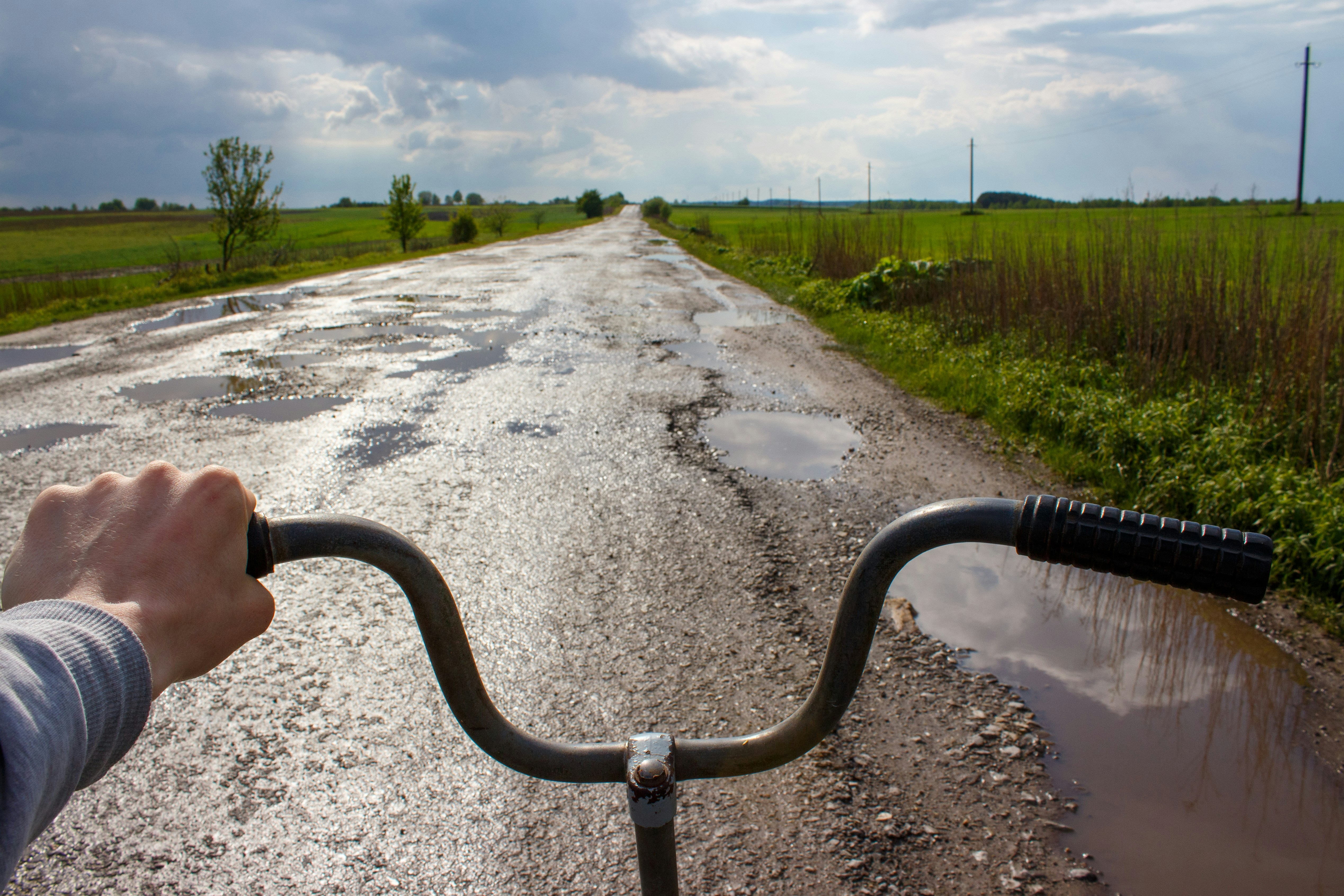 a person riding a bike down a muddy road