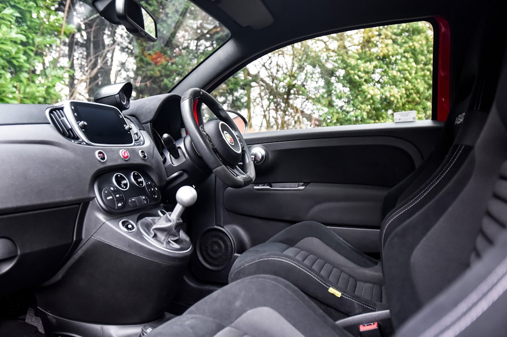 the interior of a car with a steering wheel and dashboard