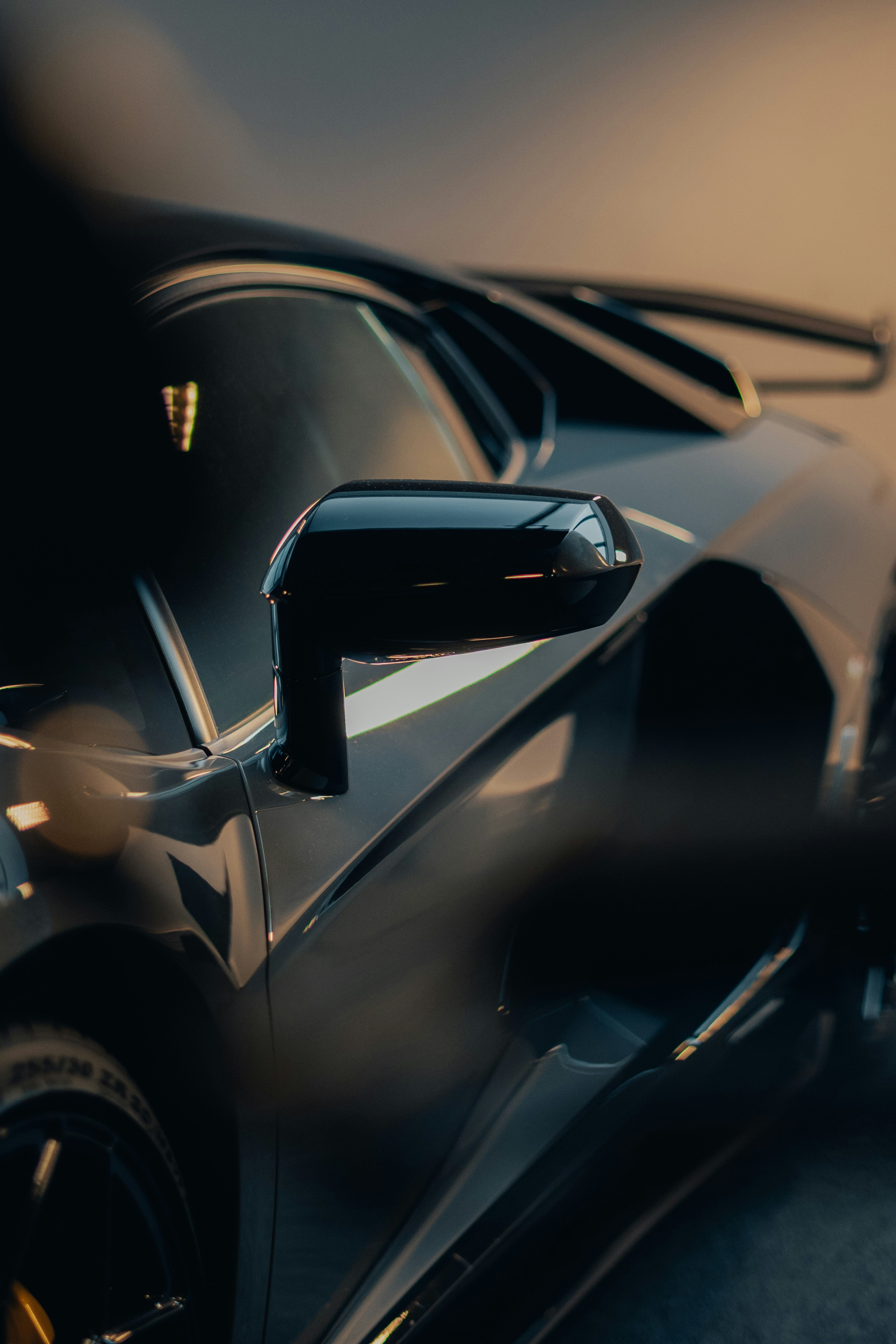 a black sports car parked in a parking lot