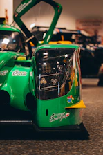 Close-up of sleek racing gear with green accents glowing under dark lighting.