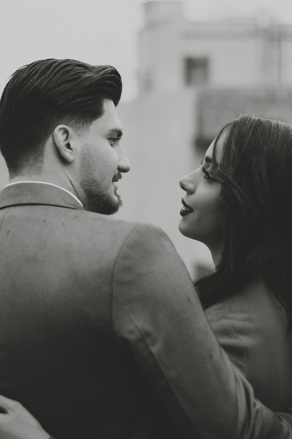 a man and a woman are looking at each other