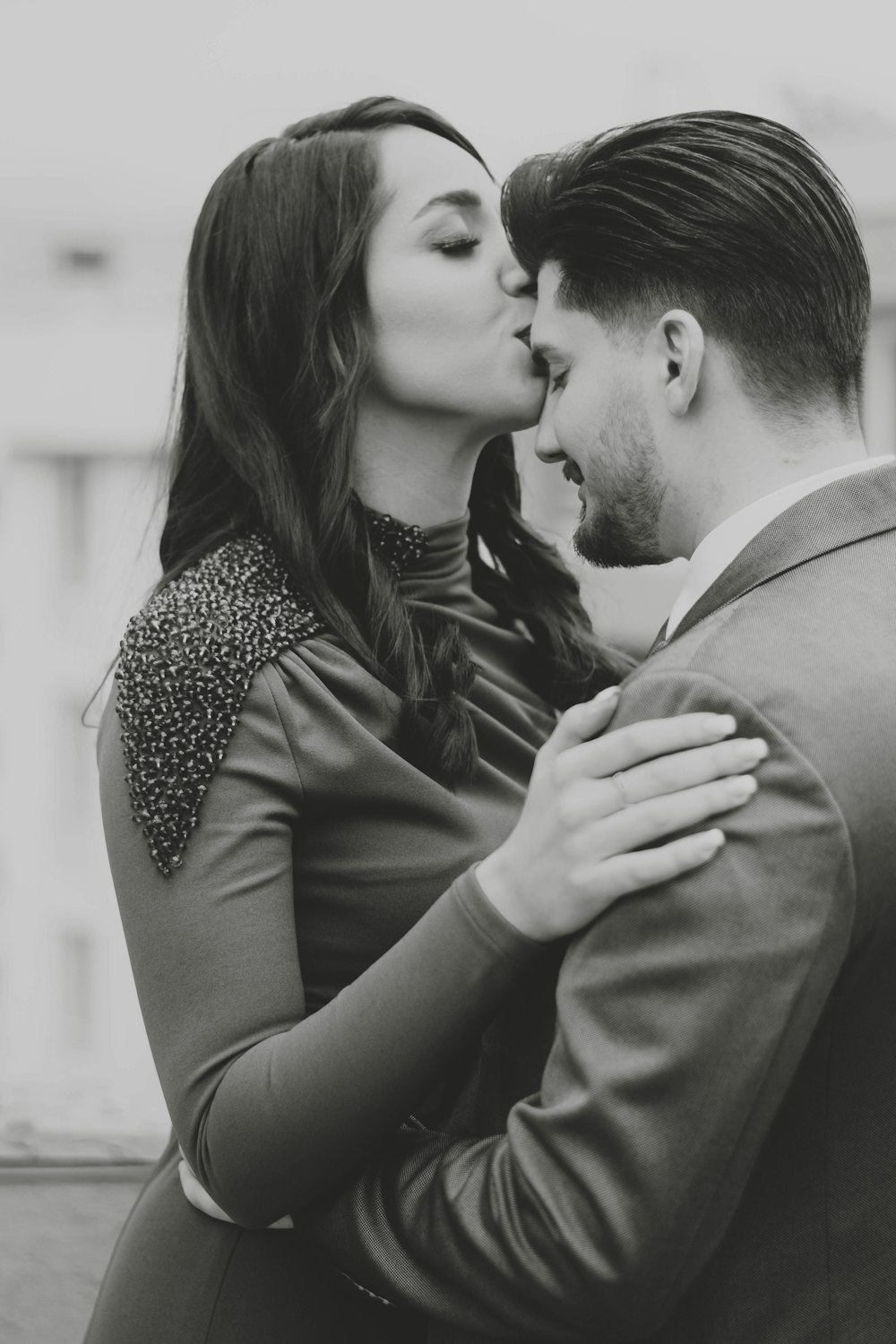 a man and a woman kissing each other