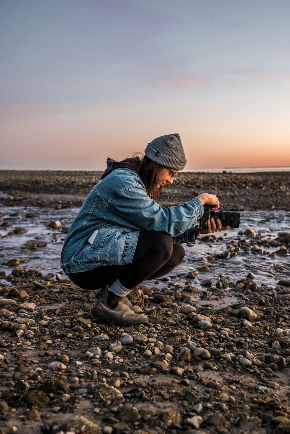 a woman kneeling down to take a picture