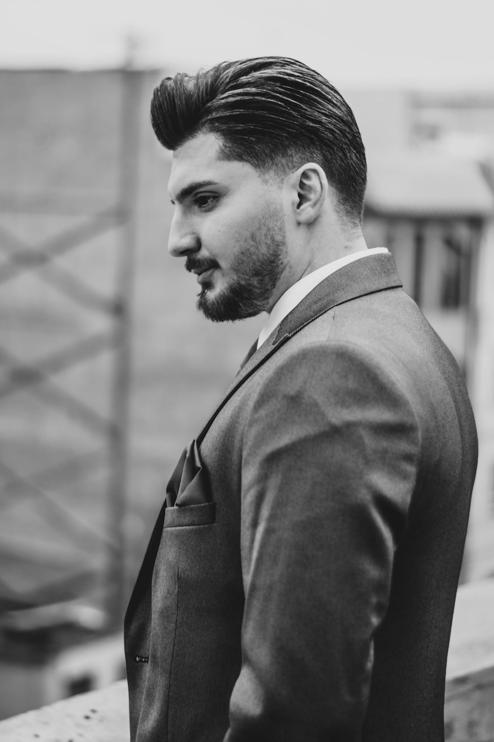 a man in a suit and tie looking off into the distance