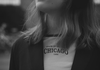 a woman wearing headphones standing in front of a building